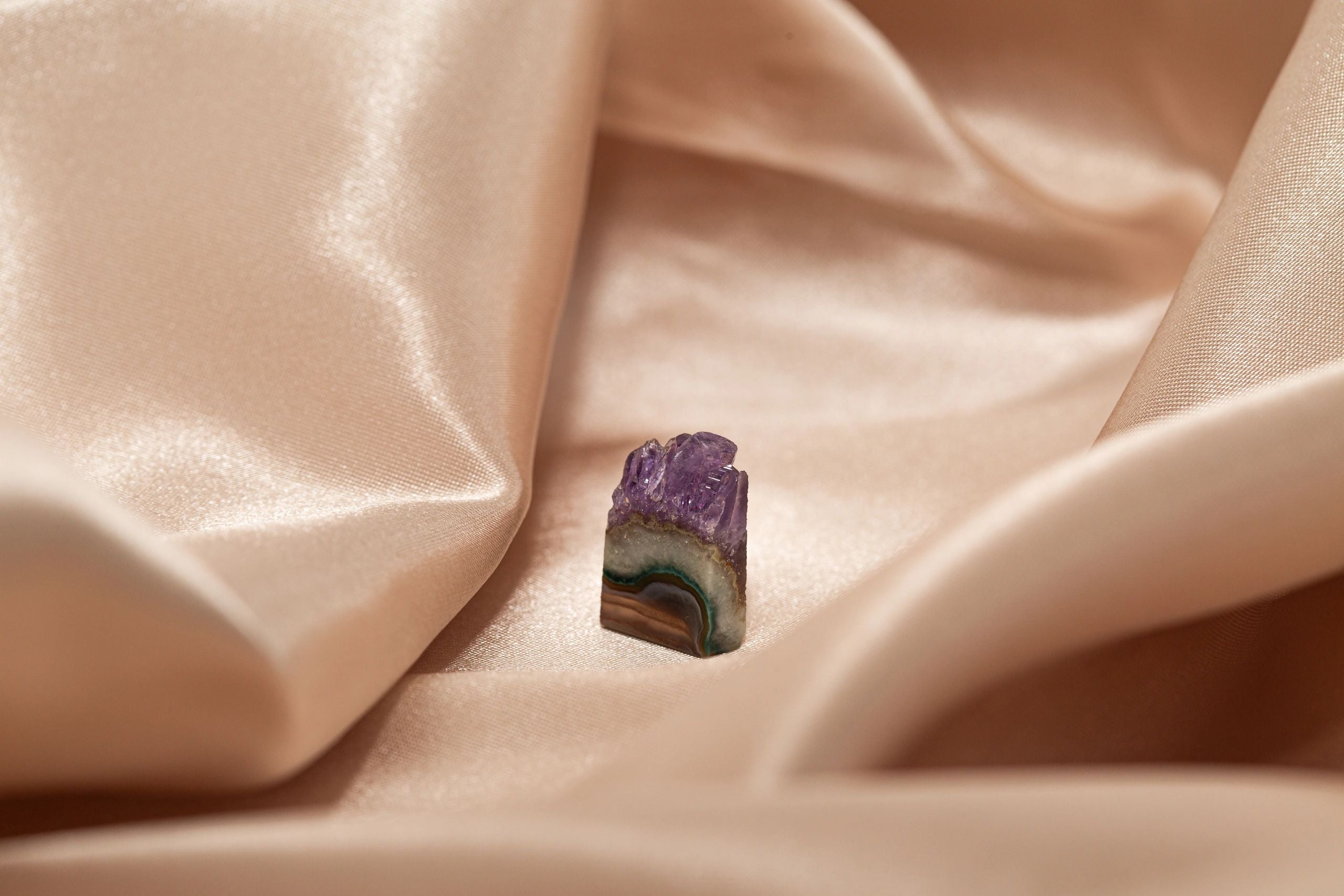 Kalistei — Raw amethyst stone on silk